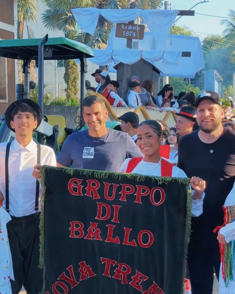 Serginho Vidigal ao lado de dançarinos típicos na festa da imigração italiana
